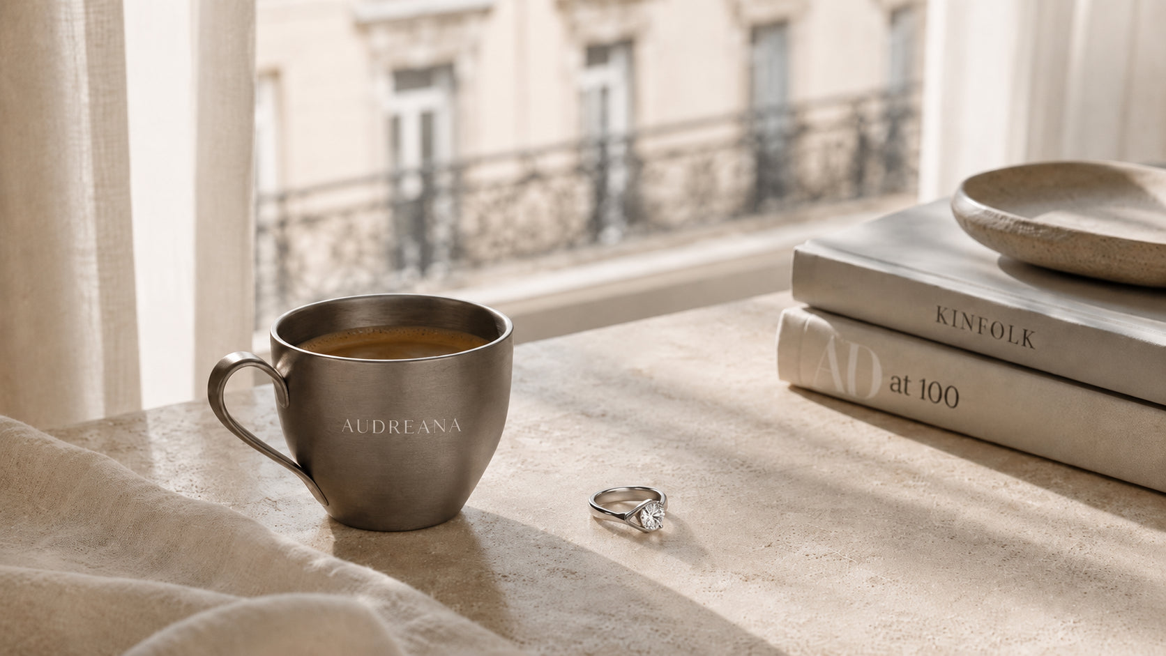 Audreana diamond ring beside coffee and books